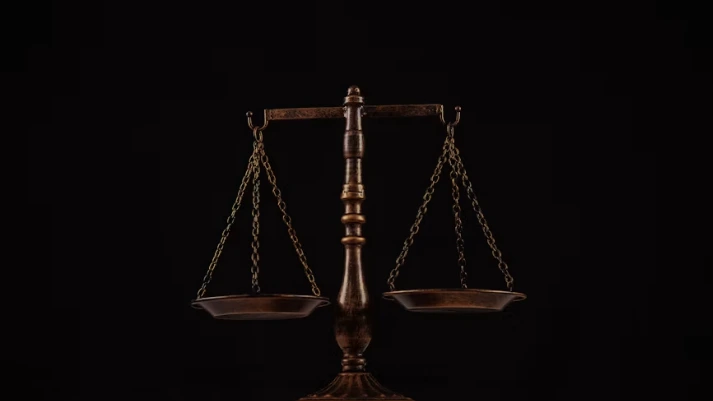 A stack of law books representing the individual copyright lawsuits authors filed against AI companies after opting out of the Anthropic settlement